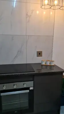 a kitchen with a black counter top and a stove at NO LOADSHEDDING 1 Bedroom Apartment in Trichardt