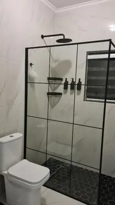 a bathroom with a glass shower with a toilet at NO LOADSHEDDING 1 Bedroom Apartment in Trichardt