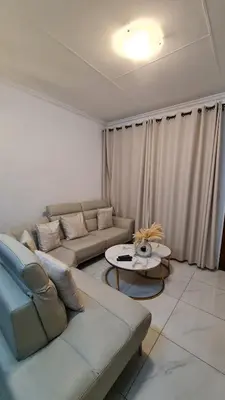 a living room with a couch and a table at NO LOADSHEDDING 1 Bedroom Apartment in Trichardt