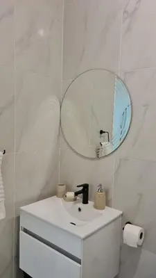 a white bathroom with a sink and a mirror at NO LOADSHEDDING 1 Bedroom Apartment in Trichardt
