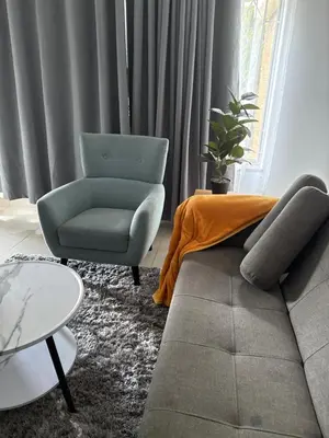 a living room with a couch and a chair at khayelihle guest house in Benoni