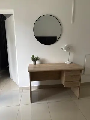 a dressing table with a mirror and a lamp on it at khayelihle guest house in Benoni