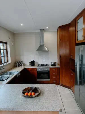 a kitchen with a bowl of oranges on a counter at The Garden Den in Nelspruit