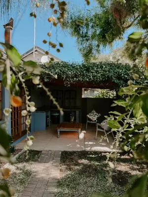 a patio with a bench and a table at The Garden Den in Nelspruit