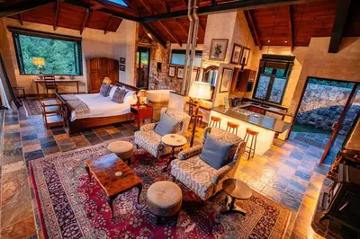 an aerial view of a living room with a bed at Private luxurious suite on Heysbrook Estate halfway to Kruger National Park in Waterval-Onder