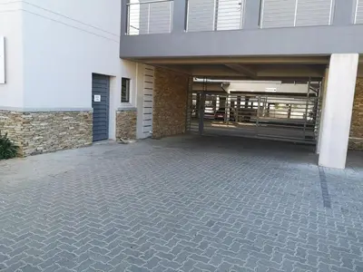 an empty parking lot in front of a building at Junction 502, Menlo Park in Pretoria