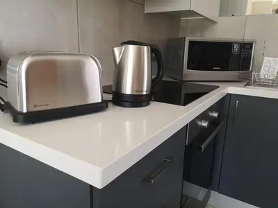 a kitchen counter with a toaster and a microwave at Junction 502, Menlo Park in Pretoria