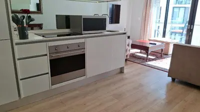 a kitchen with a stove and a microwave at Luxury Penthouse Apartment Waterfall Midrand in Midrand
