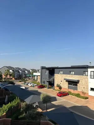 an aerial view of a building with a parking lot at Aesthetic Luxury 2 bedroom penthouse in Pretoria