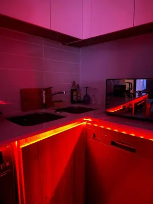 a kitchen with red lights on the counters and a sink at Aesthetic Luxury 2 bedroom penthouse in Pretoria