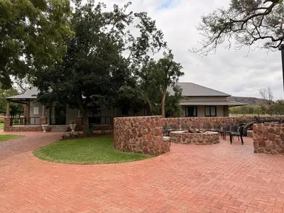 a brick patio in front of a house at Welgedacht Lodge in Cullinan