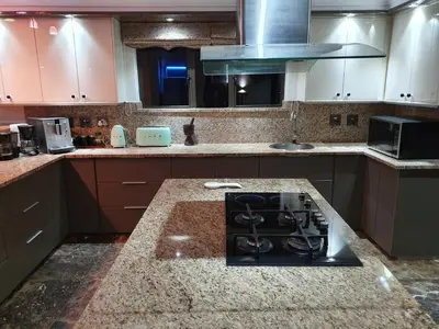 a kitchen with a stove and a counter top at The Villa Luxe Hartbeespoort Golf and Wildlife Estate in Hartbeespoort