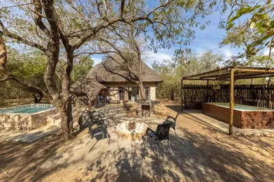 a group of chairs sitting in front of a house at Elephants Hide in Marloth Park