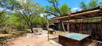 a hot tub in a yard next to a building at Elephants Hide in Marloth Park