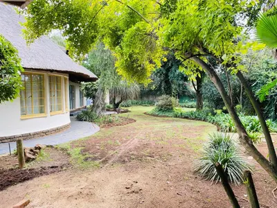a house with a dirt road next to a yard at Harmony Spaces in Kempton Park