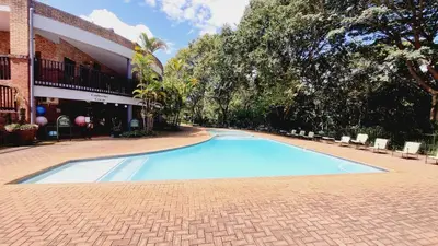 a large blue swimming pool next to a building at Chestnut at Greenway Woods in White River