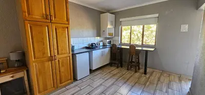 a kitchen with a counter and a table and a window at Chestnut at Greenway Woods in White River