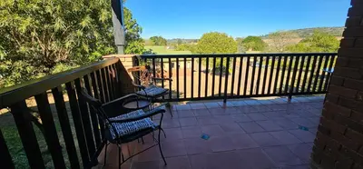 two chairs on a balcony with a fence at Chestnut at Greenway Woods in White River