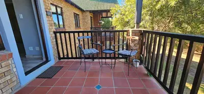 a porch with chairs and tables on a balcony at Chestnut at Greenway Woods in White River
