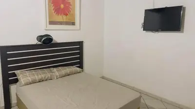a bed in a room with a television on the wall at De whytehouse Mogalatsane in Marble Hall