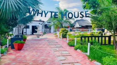 a house with a sign that reads unique house at De whytehouse Mogalatsane in Marble Hall