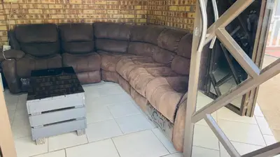 a brown leather couch sitting in a room at De whytehouse Mogalatsane in Marble Hall
