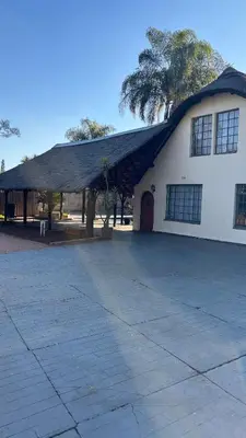 a large white building with a gambrel roof at Harmony Spaces in Kempton Park
