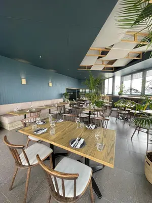 a restaurant with a large wooden table and chairs at The Capital Trilogy Menlyn Maine Apartment in Pretoria
