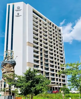 a large white building with a sign on it at The Capital Trilogy Menlyn Maine Apartment in Pretoria