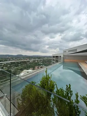 a swimming pool on the roof of a building at The Capital Trilogy Menlyn Maine Apartment in Pretoria