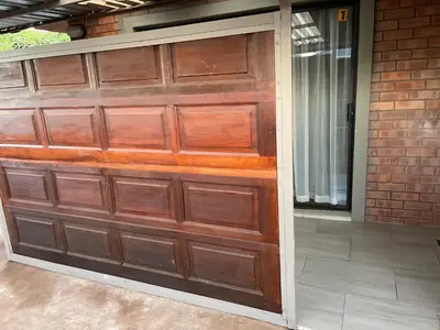 a wooden garage door on a house at Ekhaya,private room with patio 1 in Mokopane