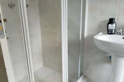 a bathroom with a shower and a sink at Sunninghill apartment in Sandton