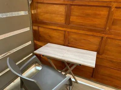 a desk and a chair next to a wooden wall at Private Room with patio 2 in Mokopane