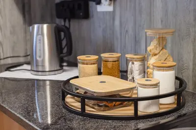 a counter with a tray of bread and jars of food at Hippo's Rest in Ellisras