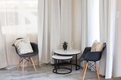 a table and chairs in a room with a window at Hippo's Rest in Ellisras