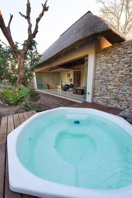 a large bath tub in front of a house at Villa Aloe Vera in Hoedspruit
