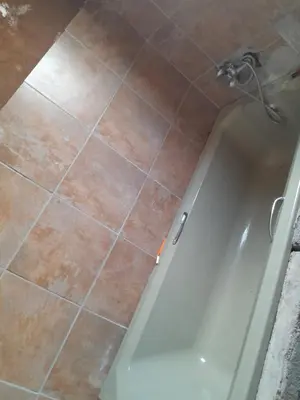 a bathroom with a shower and a tile floor at One night in Burgersfort