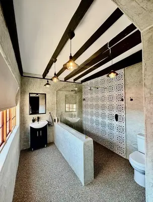 a bathroom with a sink and a toilet at Stone Cottage in Waterval Boven