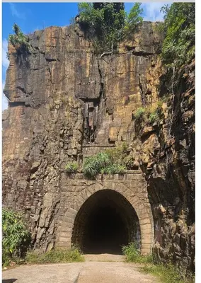 a tunnel in the side of a rocky mountain at Stone Cottage in Waterval Boven