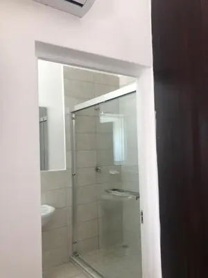 a bathroom with a shower with a glass door at Spring Acres Guesthouse in Nelspruit