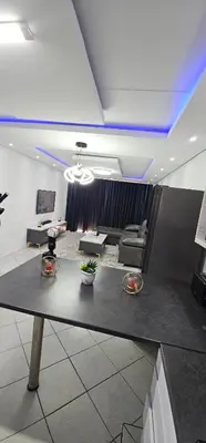a living room with a couch and a table at The Villa in Midrand