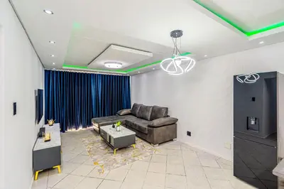 a living room with a couch and a table at The Villa in Midrand