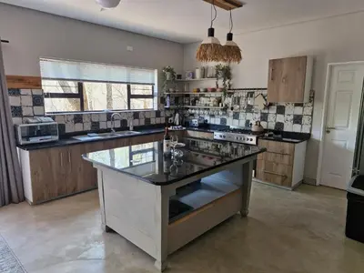 a kitchen with a large island in the middle at Tusker House Kruger in Marloth Park