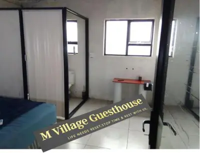 a bedroom with a window and a sign on the door at Mokoena Village guesthouse in Akasia