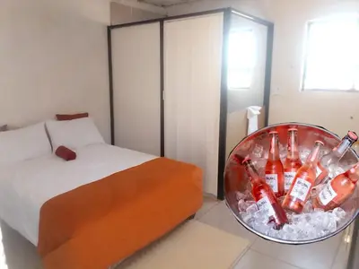 a room with a bed and a bowl of cocacolas at Mokoena Village guesthouse in Akasia