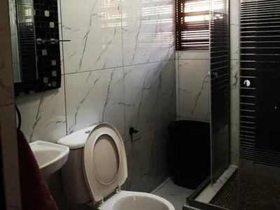a bathroom with a toilet and a sink at Carissa Street Self-catering Units in Burgersfort