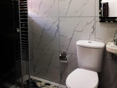 a bathroom with a toilet and a sink at Carissa Street Self-catering Units in Burgersfort