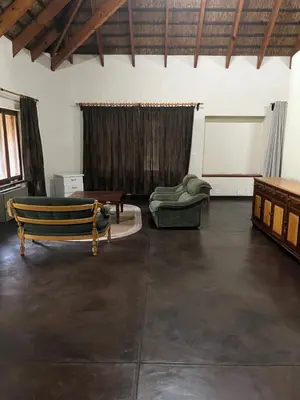 a living room with a couch and a table at Soutpansberg Lodge Louis Trichardt