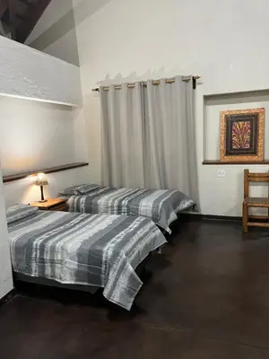 two beds sitting next to each other in a room at Soutpansberg Lodge Louis Trichardt