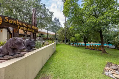 a park with two statues of animals on a wall at Sanbonani Resort Chalets in Hazyview
